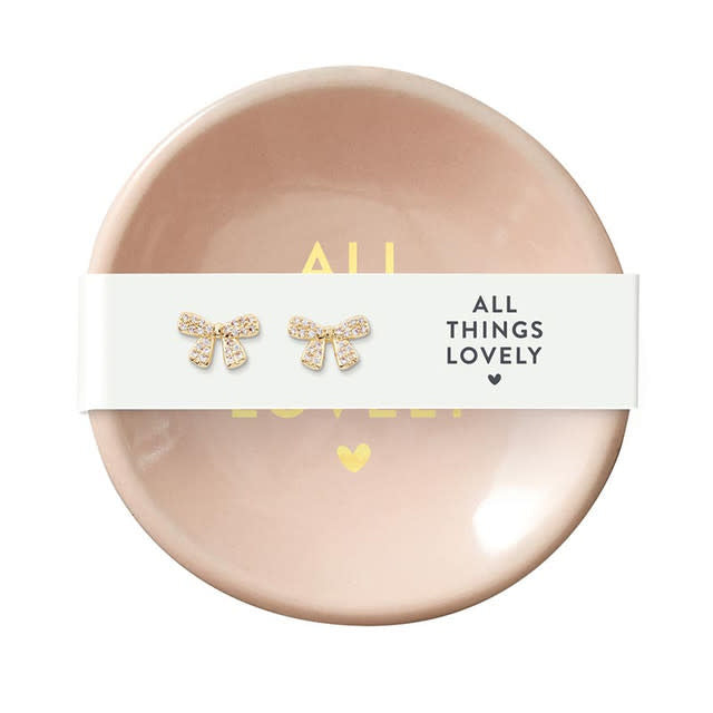 Ceramic ring dish in neutral tone holding earrings with zinc alloy posts