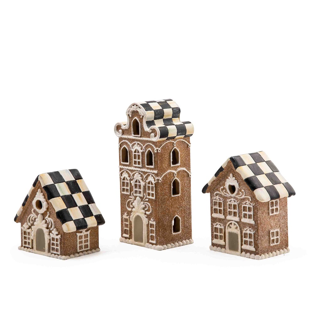 Illuminated gingerbread house made of resin with warm interior lighting.