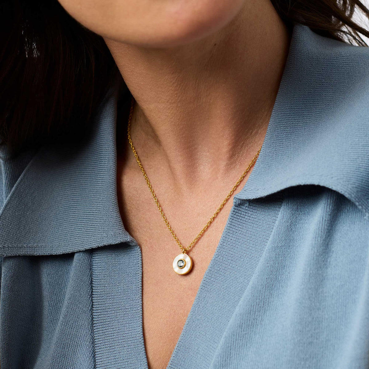 Delicate adjustable necklace with a mother-of-pearl pendant on gold plate.