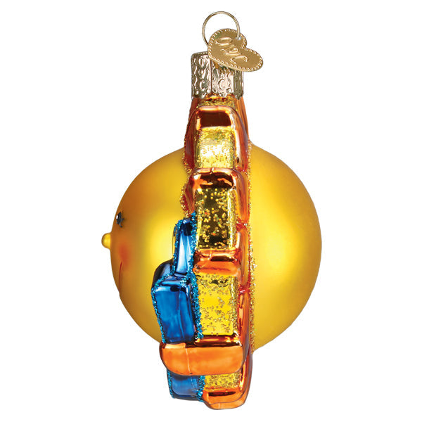 Side view of a yellow glass sun ornament with orange and blue glittered rays and a heart charm.