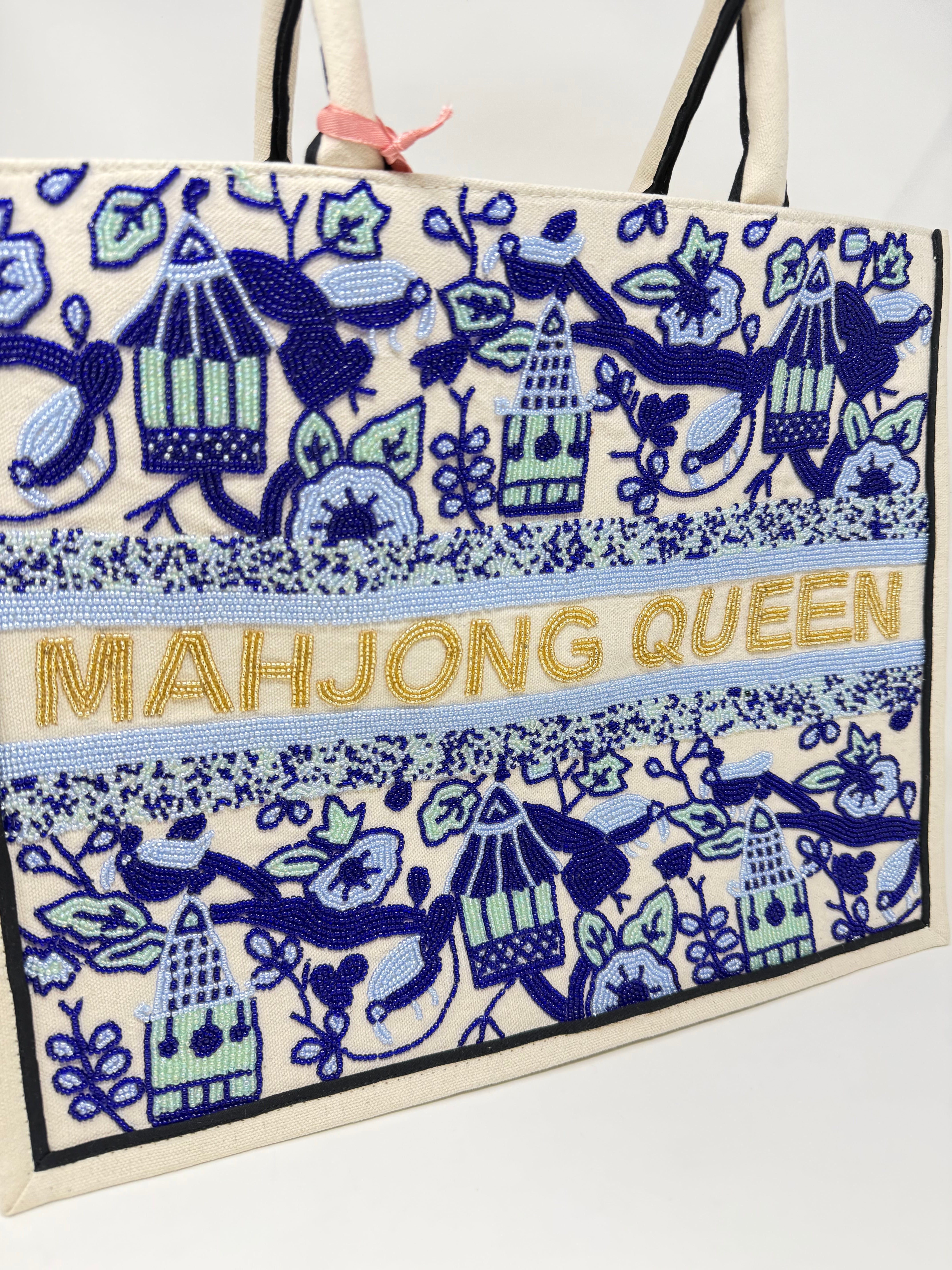 Hand-beaded cream tote bag with blue pagoda patterns and gold 'MAHJONG QUEEN' text.