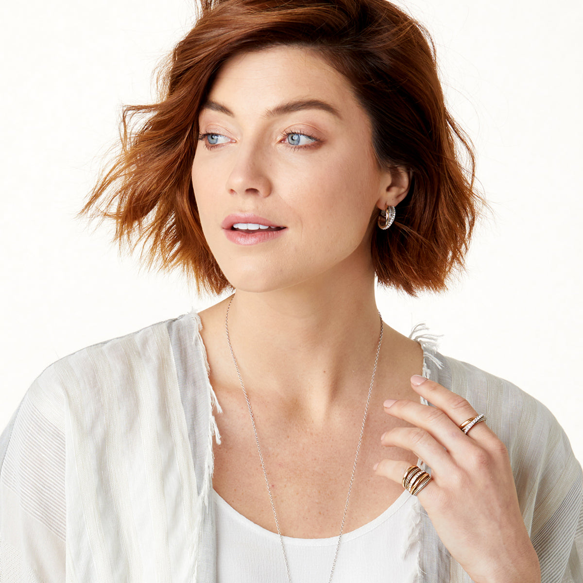 A woman wearing the Neptune's Rings Ring, a silver and gold plated band with fine quality crystals.