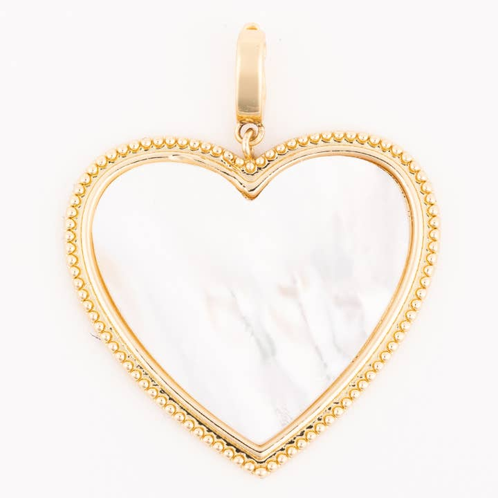 Gold-toned heart-shaped charm with a white mother-of-pearl inlay and beaded border.