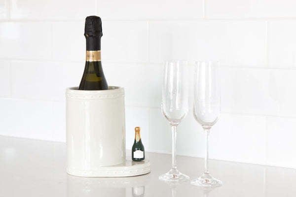 Mini champagne bottle with 'Champagne Celebration' label in gold script on white background.