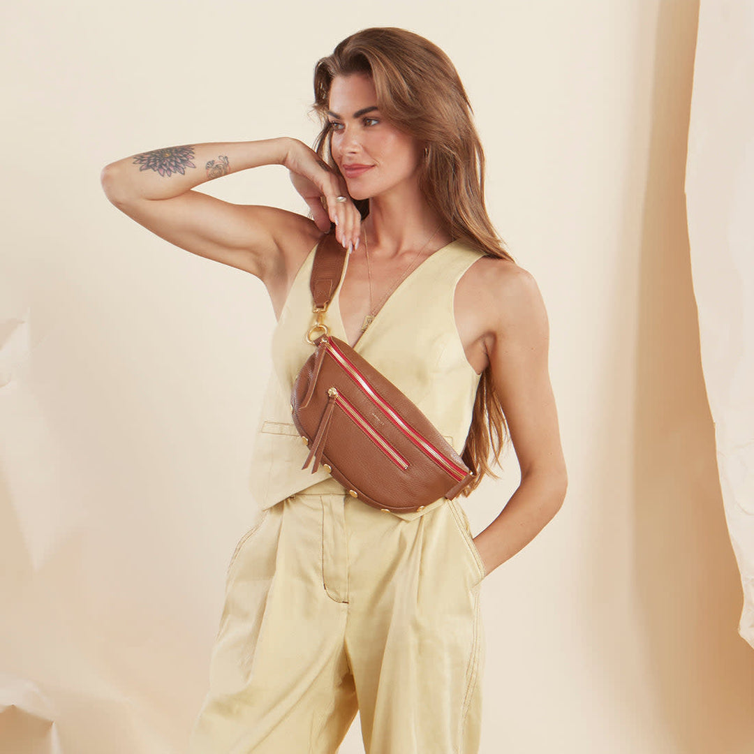 Large Charles crossbody bag in mahogany pebbled leather with brushed gold hardware and red lining.