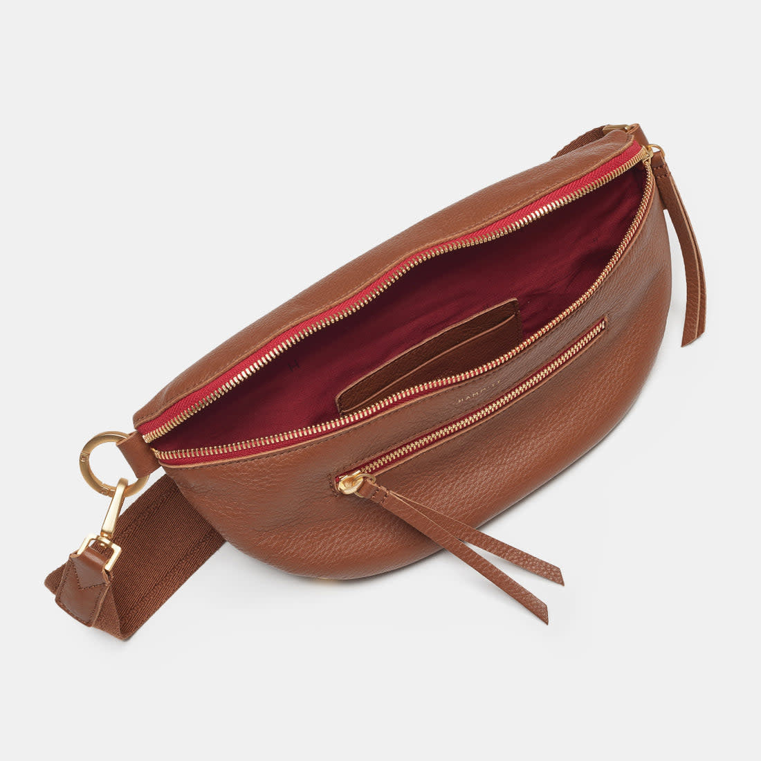 Large mahogany pebble leather crossbody bag with brushed gold hardware, red lining, and front zip pocket.