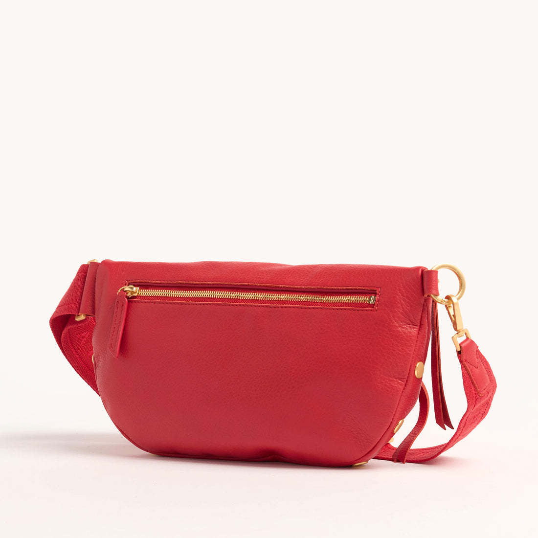 Charles crossbody bag in oxblood red pebble leather with brushed gold hardware and adjustable strap.