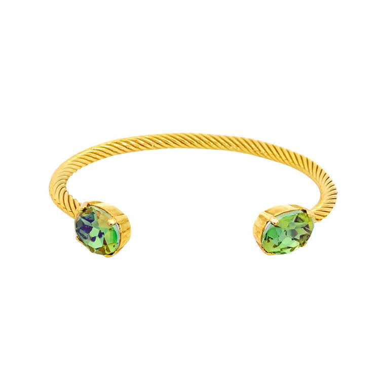 Gold plated brass cuff bracelet with high quality peridot colored crystals in an oval silhouette.