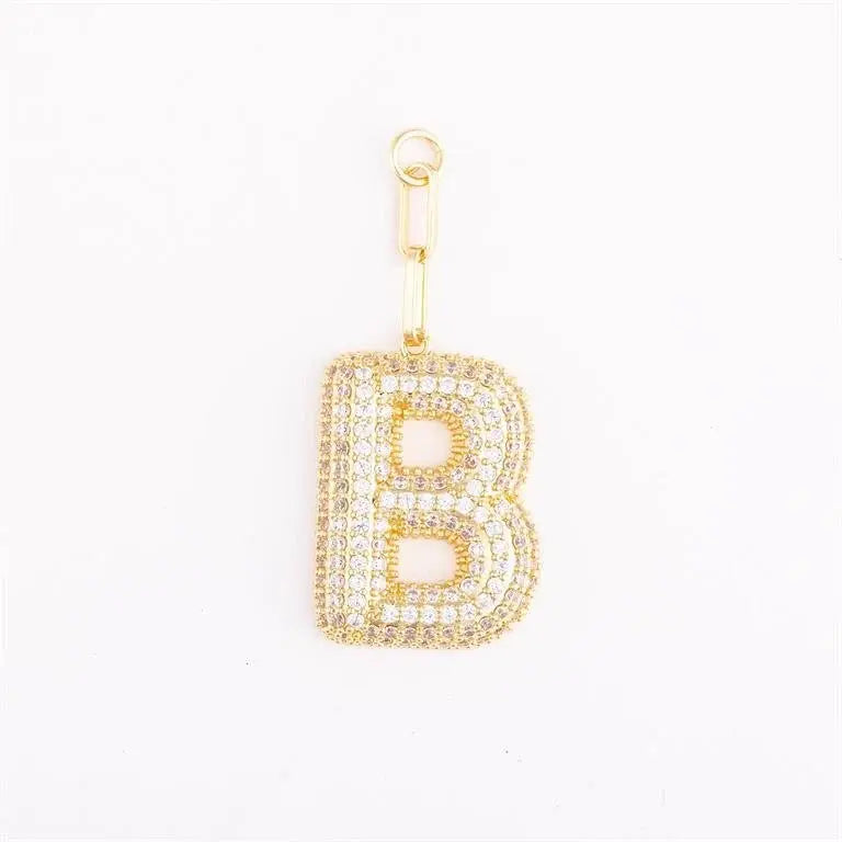 Heather-colored charm bag with pave crystal accents and an initial letter pendant on a gold-plated extender.