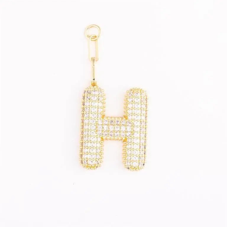 Heather-colored charm bag with gold plating and pave crystal initial detail