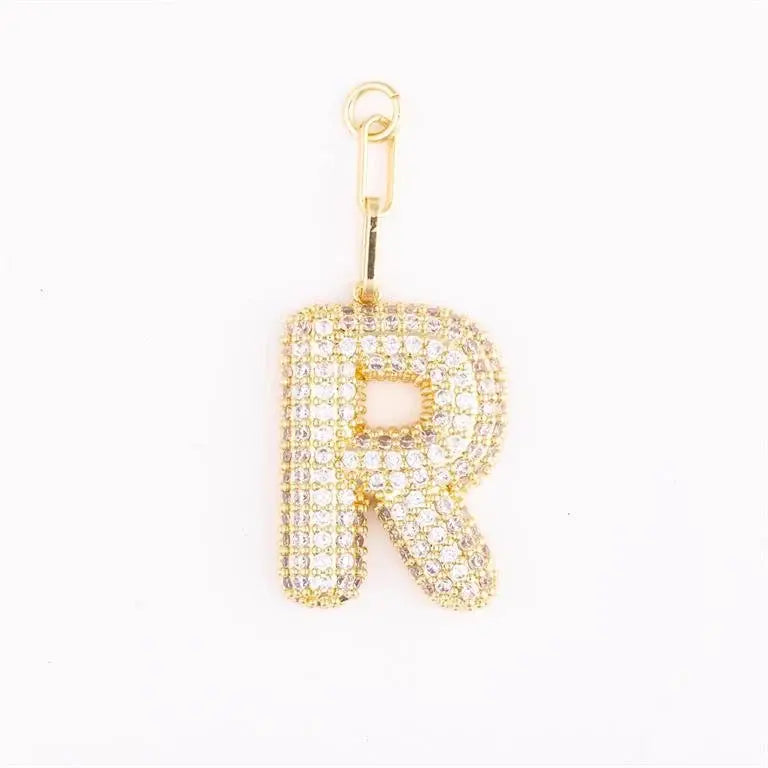 Heather-colored pave crystal charm bag accessory with gold plating and initial engraving