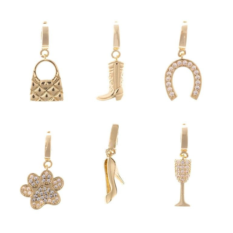 Gold-plated charm shaped like a girl with flowing hair holding sunglasses