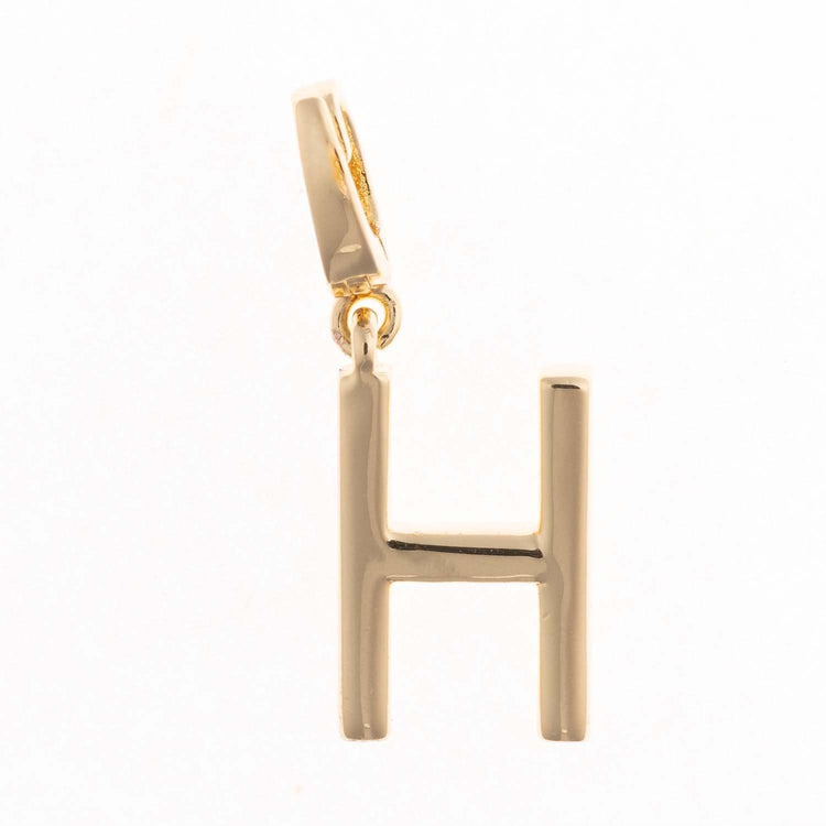 Gold-plated Charm Tia pendant with a .5-inch length featuring an intricate silhouette and nickel-free hypoallergenic material.