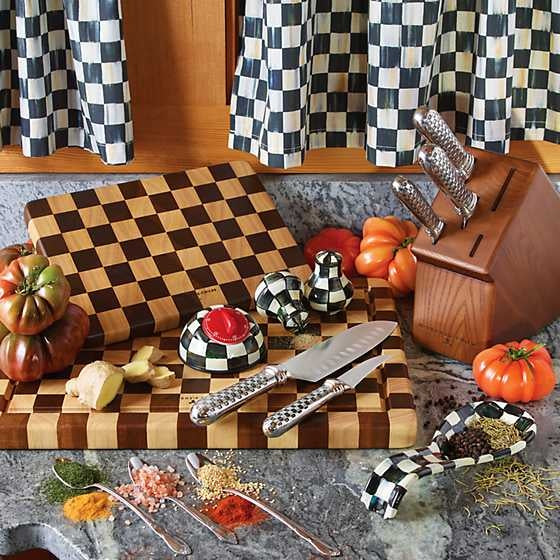 Handmade checkered acacia wood chopping board with rubberwood accents.