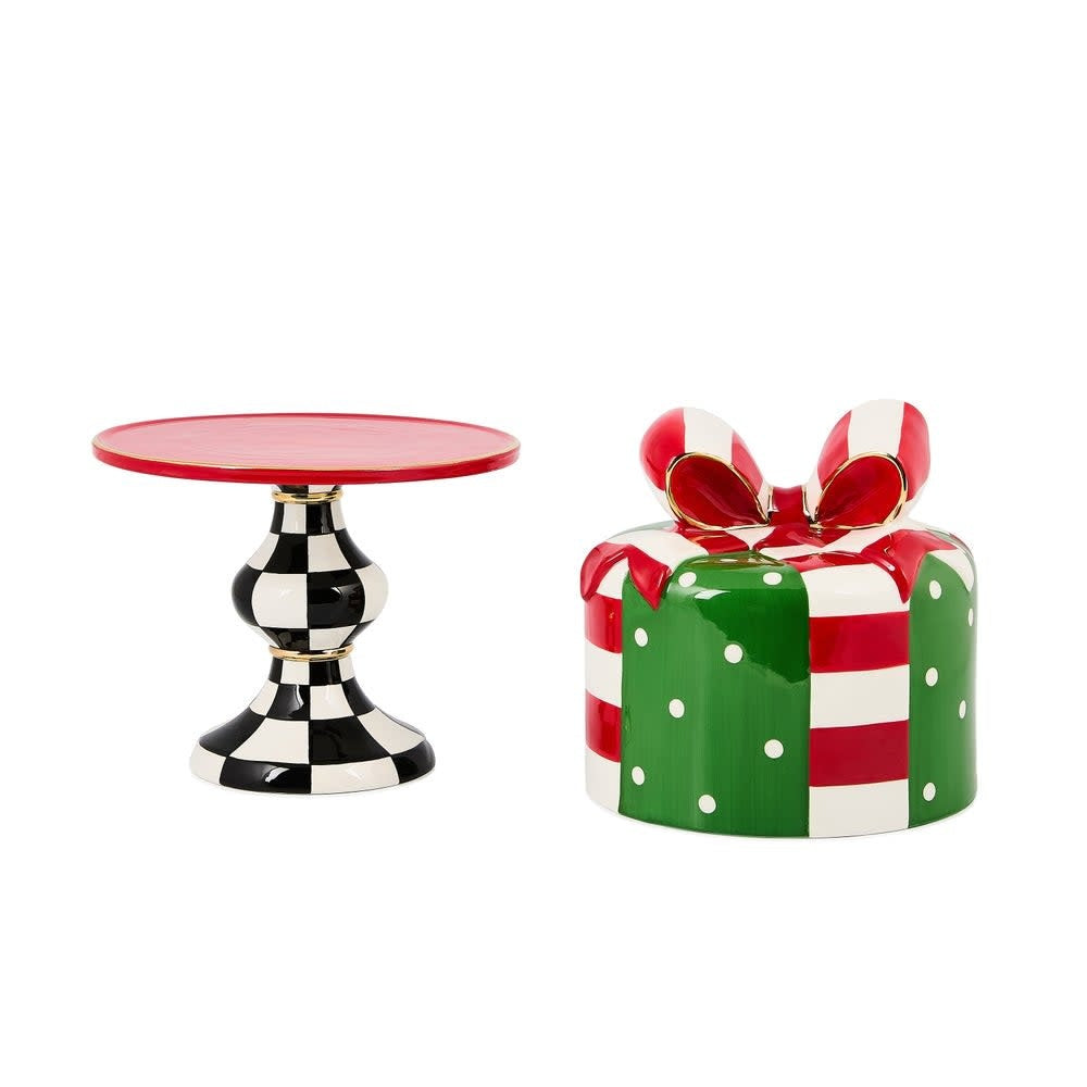 Ceramic lidded cake stand with a festive checkered pattern on the cover and pedestal base.