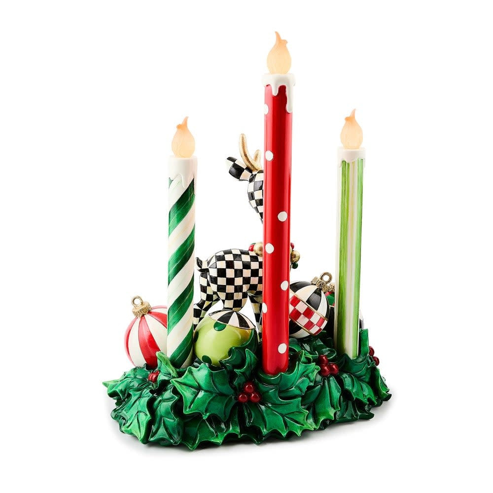 Illuminated resin deer centerpiece with candle accents in warm tones