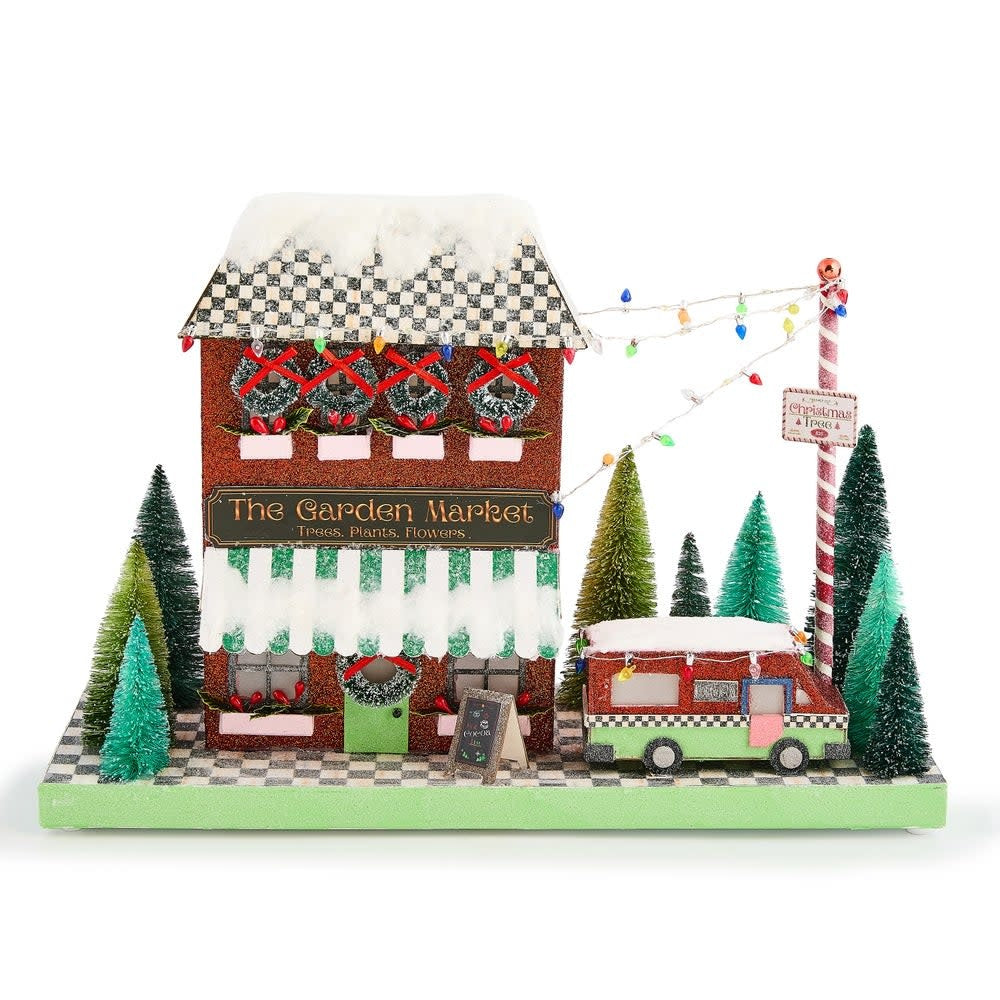 Illuminated paper house with Courtly Check roof depicting a Christmas tree farm scene.