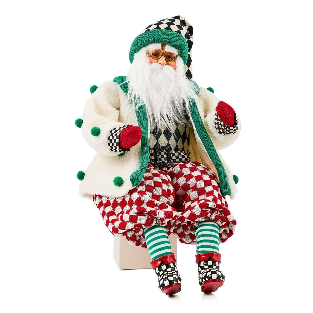 Handmade fabric Santa figurine wearing red check pants and a cozy cardigan.