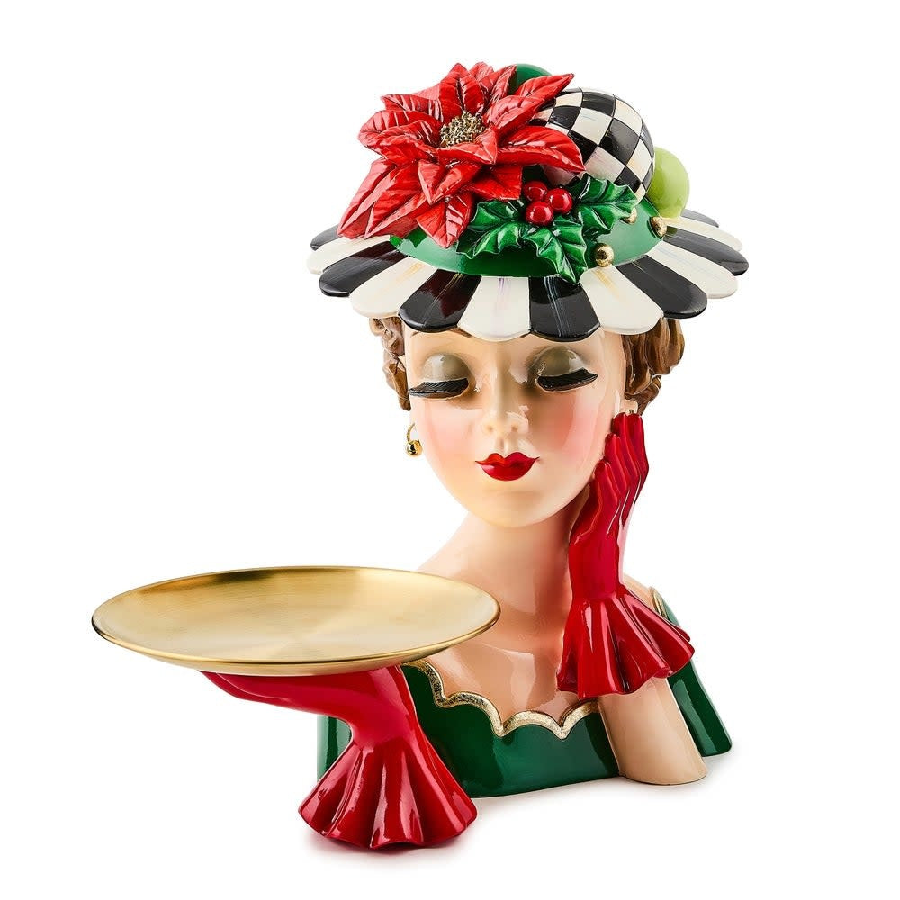 Resin figurine of a lady holding an oval gold tray with holiday decor.