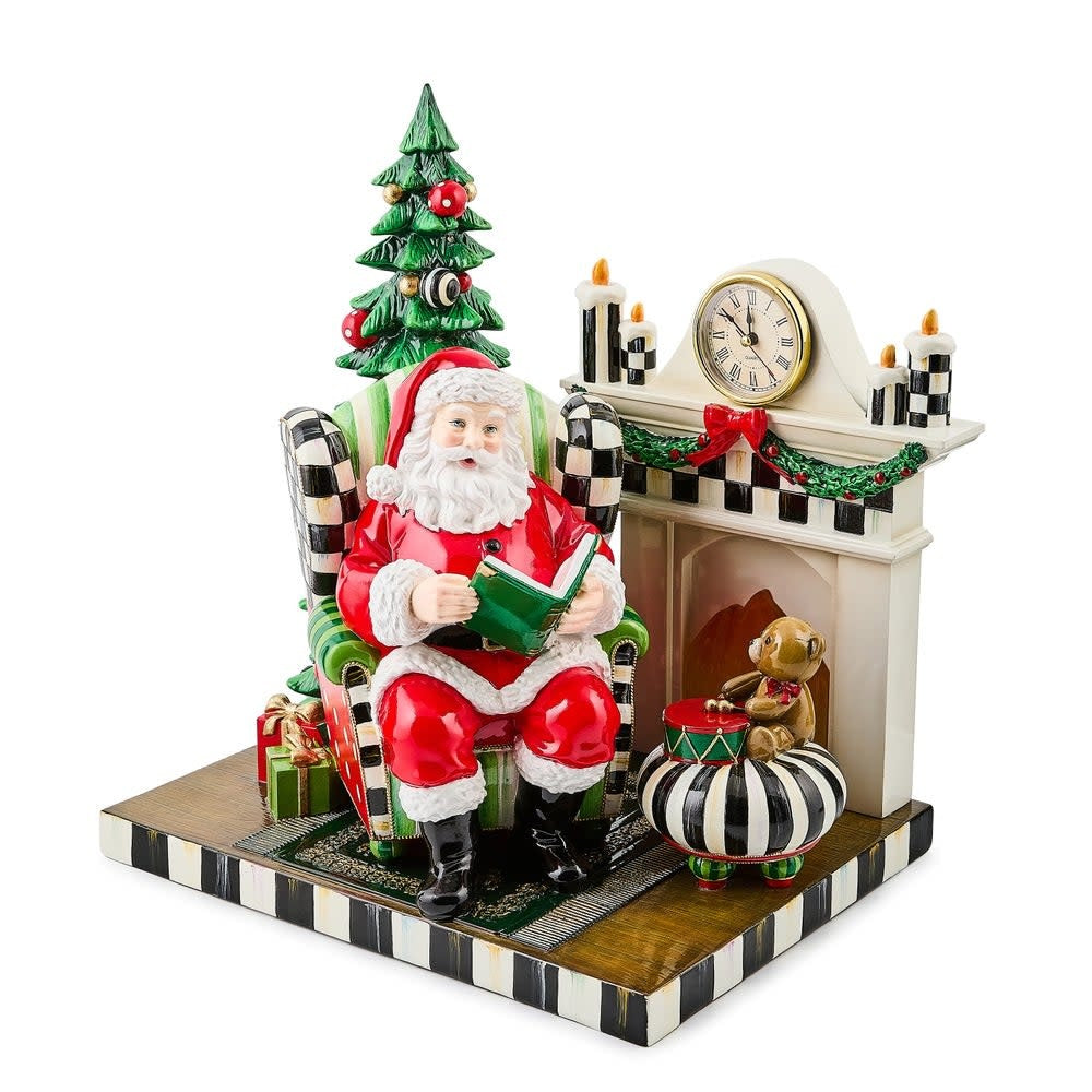Illuminated resin figurine of Santa Claus in a cozy living room with Courtly Check pattern border.