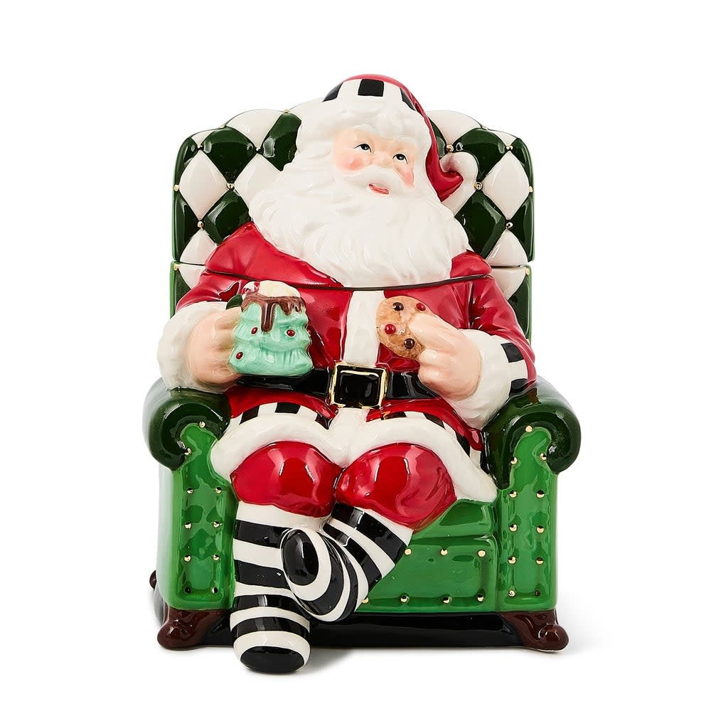 Ceramic cookie jar shaped as Santa sitting in a chair with red suit.