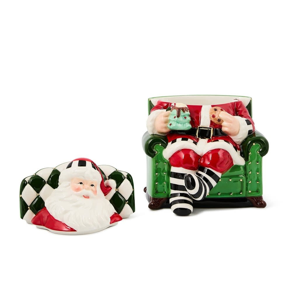 Ceramic cookie jar shaped as Santa sitting in a chair with red suit.