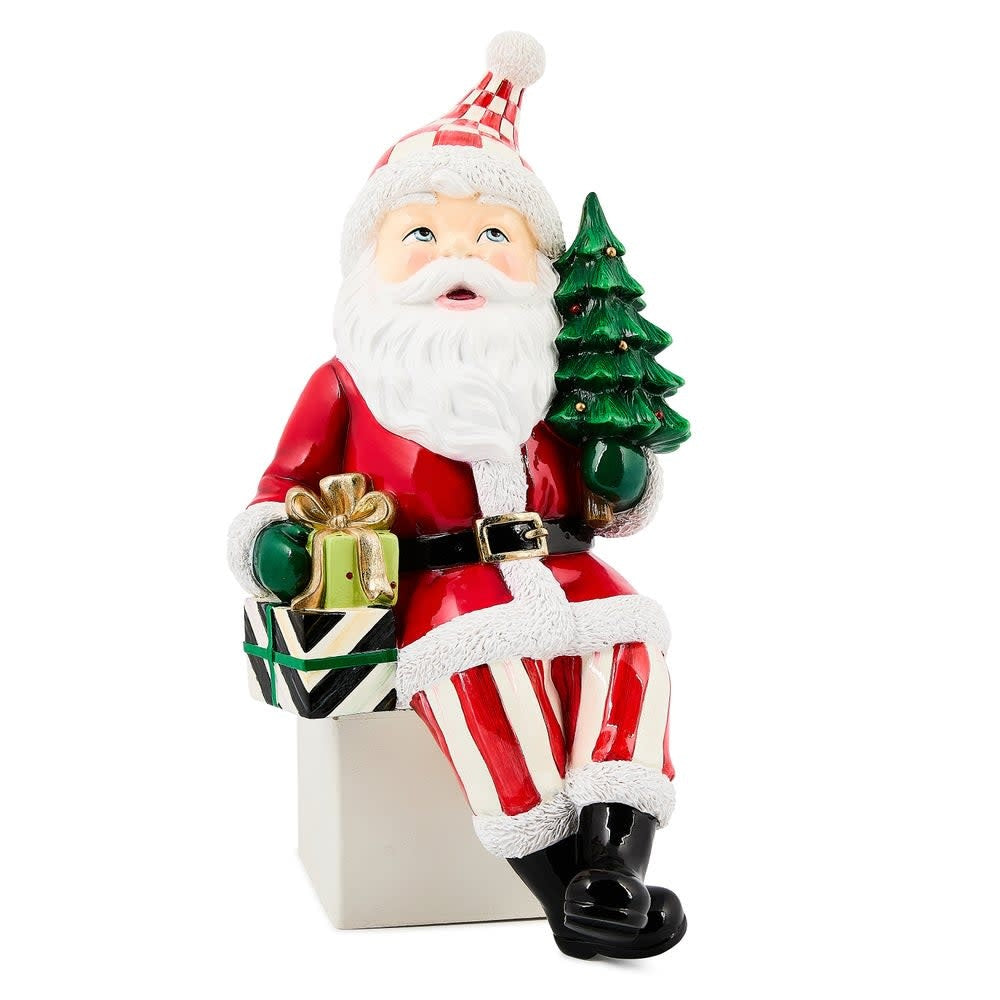 Resin Santa ledge sitter figurine with tiny tree in hand.