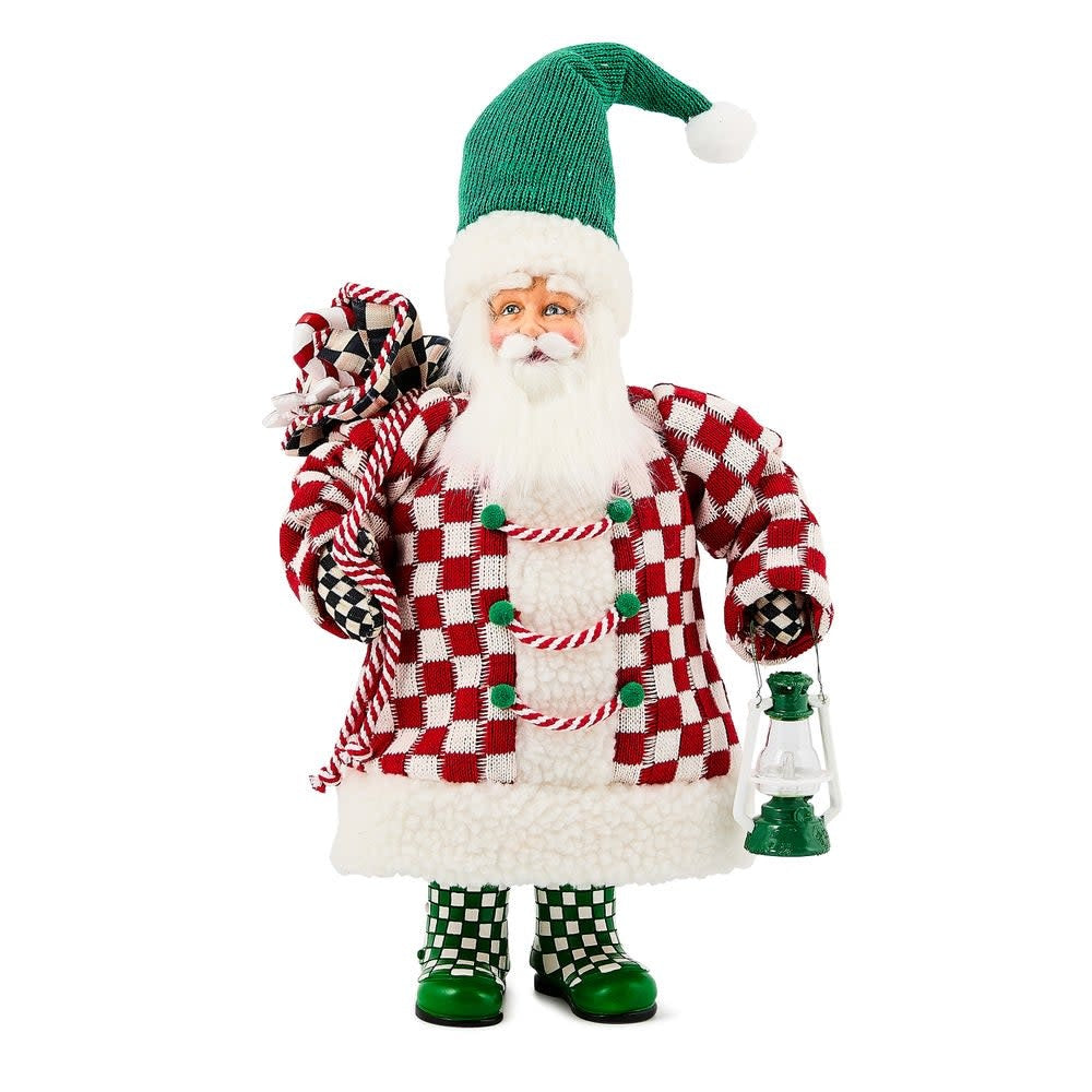 Small fabric Santa figurine with patchwork red check coat holding a holiday gift bag