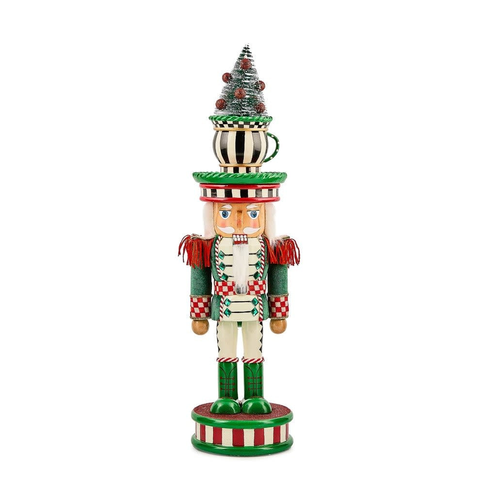 Wooden teacup nutcracker with a festive red hat standing on a base.