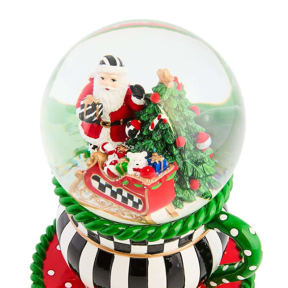 Resin teacup snow globe with glass dome featuring winter scene inside.
