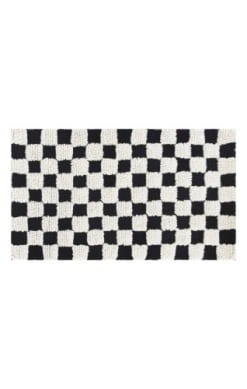 Handmade NZ wool checkerboard rug with black and white squares.