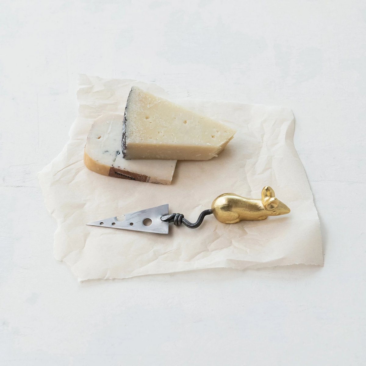 Stainless steel cheese knife with a blade shaped like a wedge of cheese and an aluminum handle molded into the shape of a mouse.