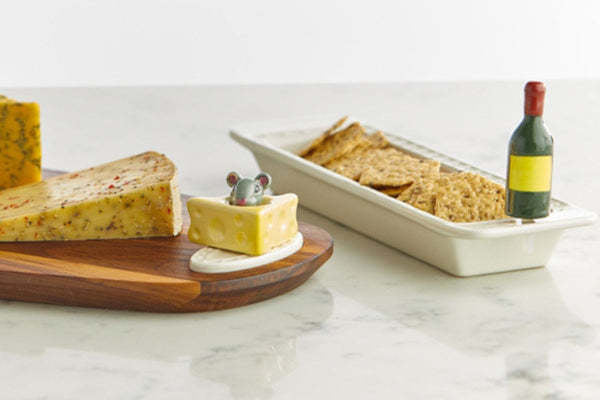 Mini cheese board shaped like a smiling face with eyes made from blue cheese.