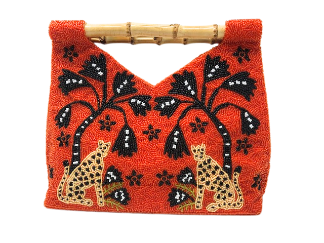 Orange beaded clutch with leopard and tree design, featuring a bamboo handle.