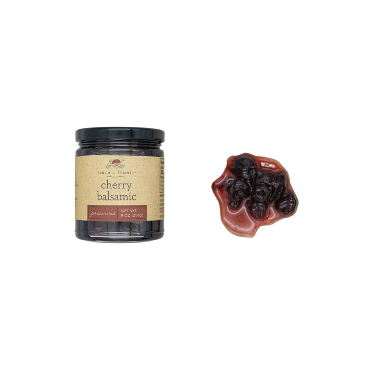 Glass jar containing cherry balsamic preserves with visible red fruit pieces.