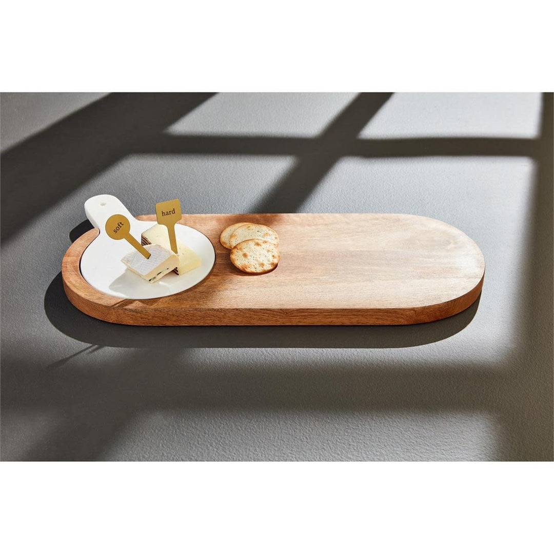 Rectangular mango wood serving board with inset white marble slab and two brass cheese markers.