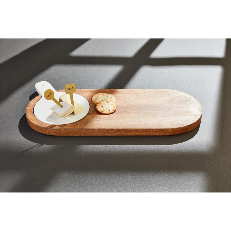 Rectangular mango wood serving board with inset white marble slab and two brass cheese markers.