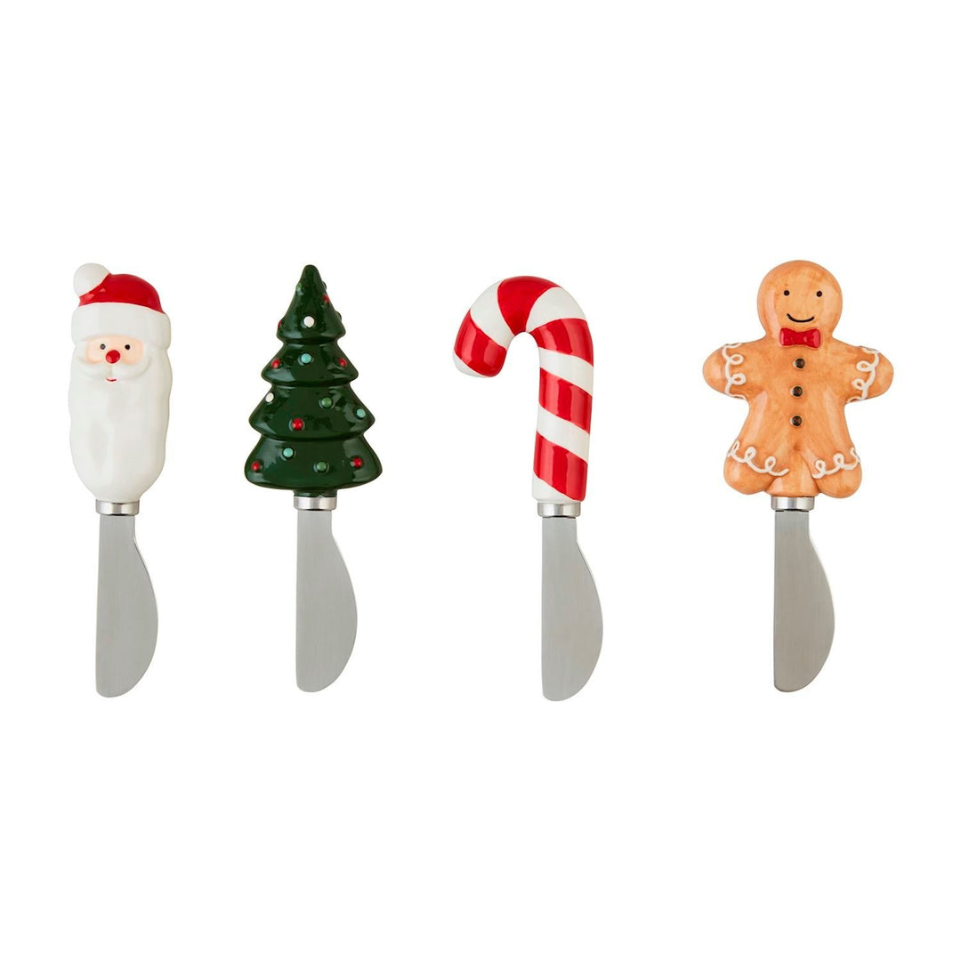 Ceramic Christmas spreader with hand-painted character handle on kraft display card.