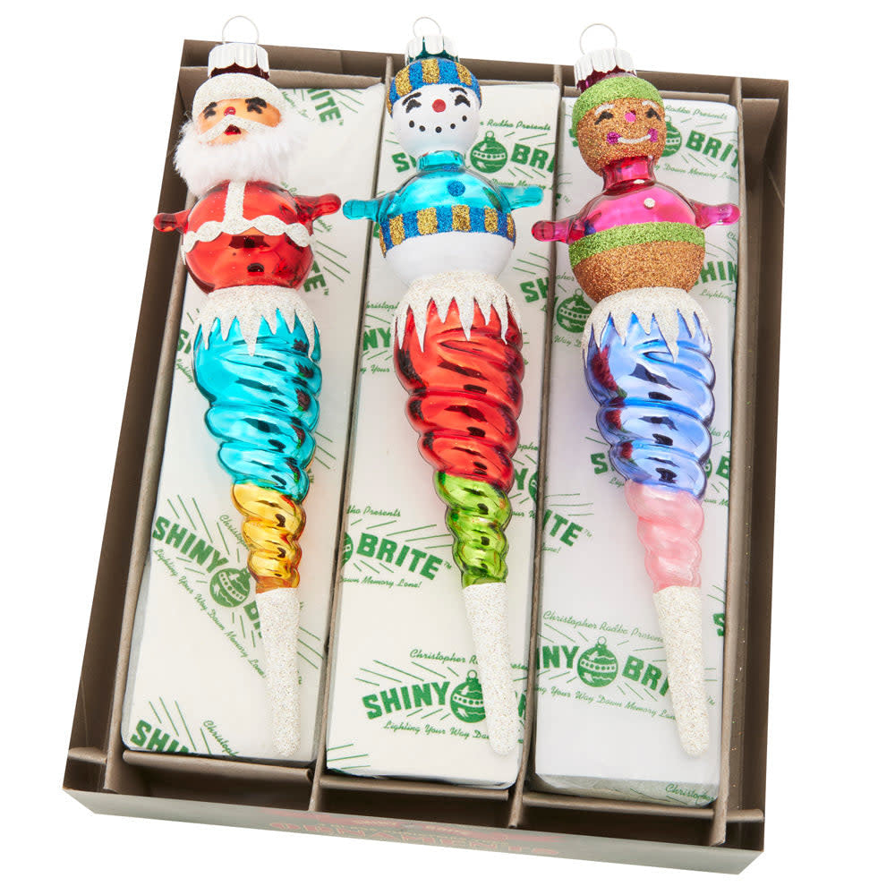 Three glass icicle ornaments featuring Santa, snowman, and gingerbread man on top.