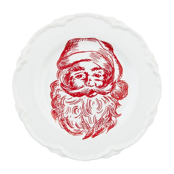 White stoneware dessert plate with a red Santa Claus illustration on the rim.