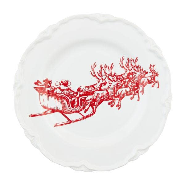 White stoneware Christmas dessert plate with red sleigh silhouette pattern.