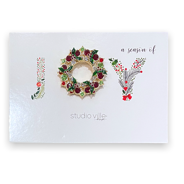 Metal Christmas glitz pin featuring a festive red and green holiday pattern with gold accents.