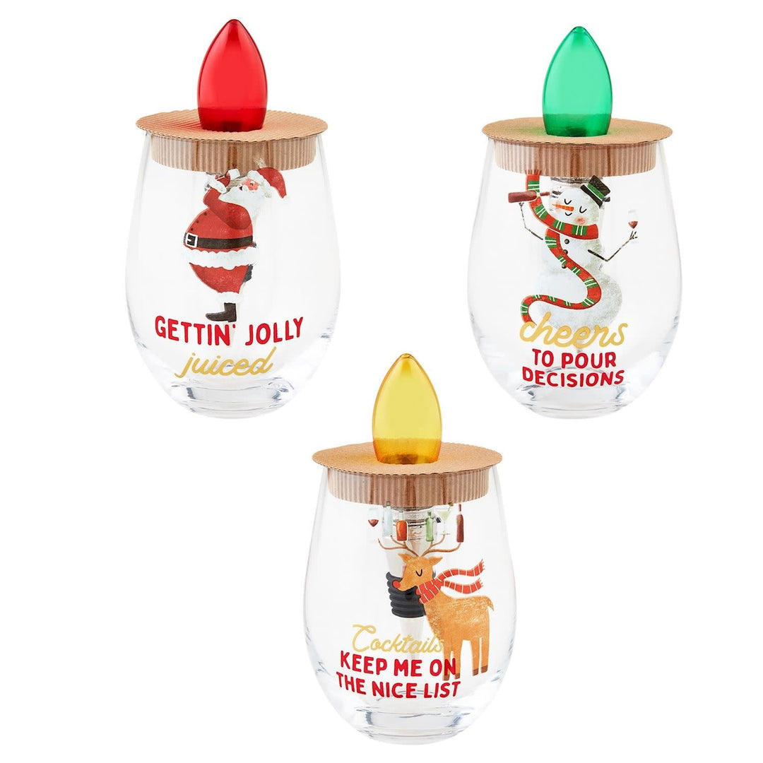 Foiled stemless wine glass with metal stopper featuring a lit Christmas bulb.