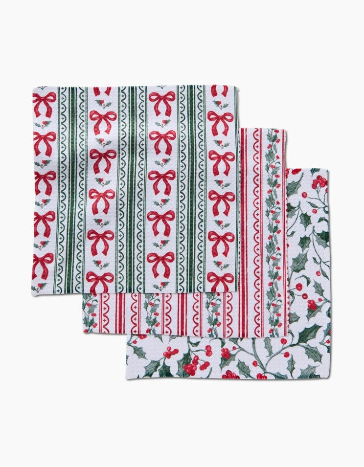 Set of three waffle weave dishcloths with Christmas ribbon patterns in red, green, and white.
