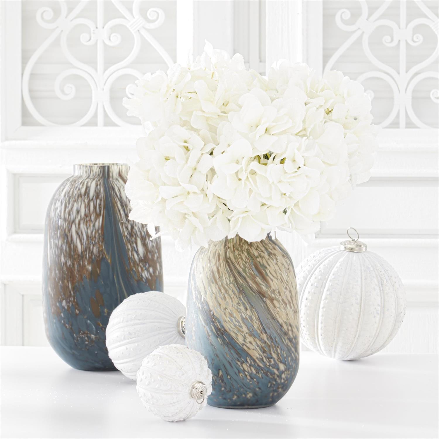 34 inch white glittered hydrangea stem in a blue and gold marbled vase with white ornaments.