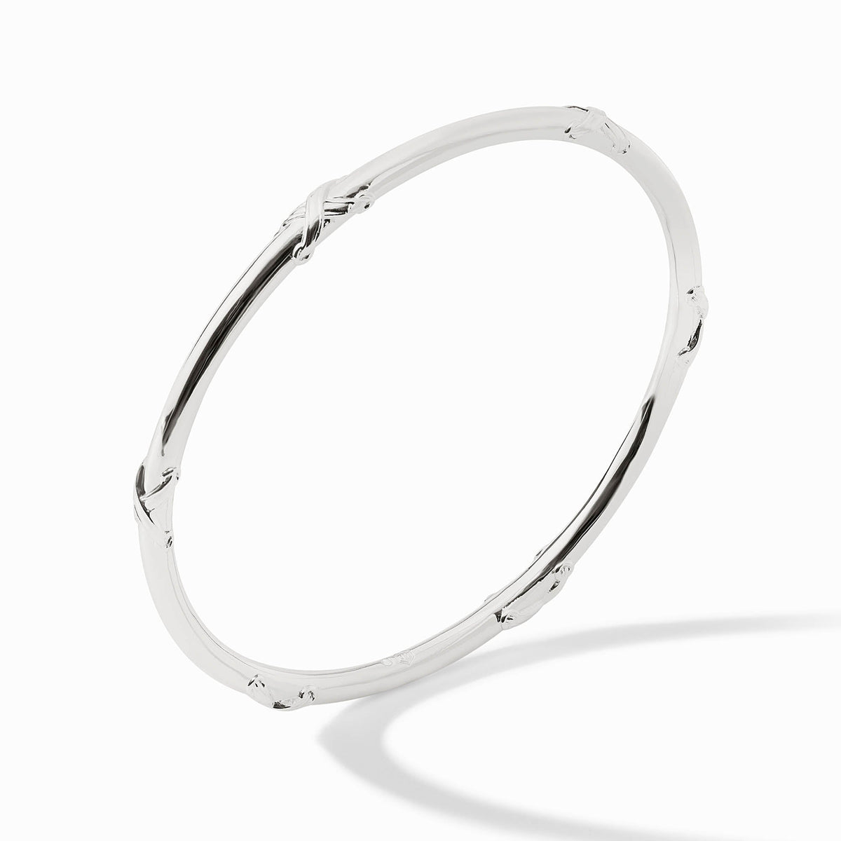 Polished silver Essex Bangle with subtle cross-over textured accents on a white background.