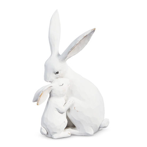 White resin figurine of a rabbit cuddling with its baby.
