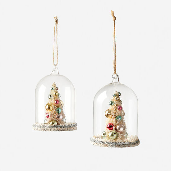 Glass dome ornament featuring a miniature Christmas tree inside.