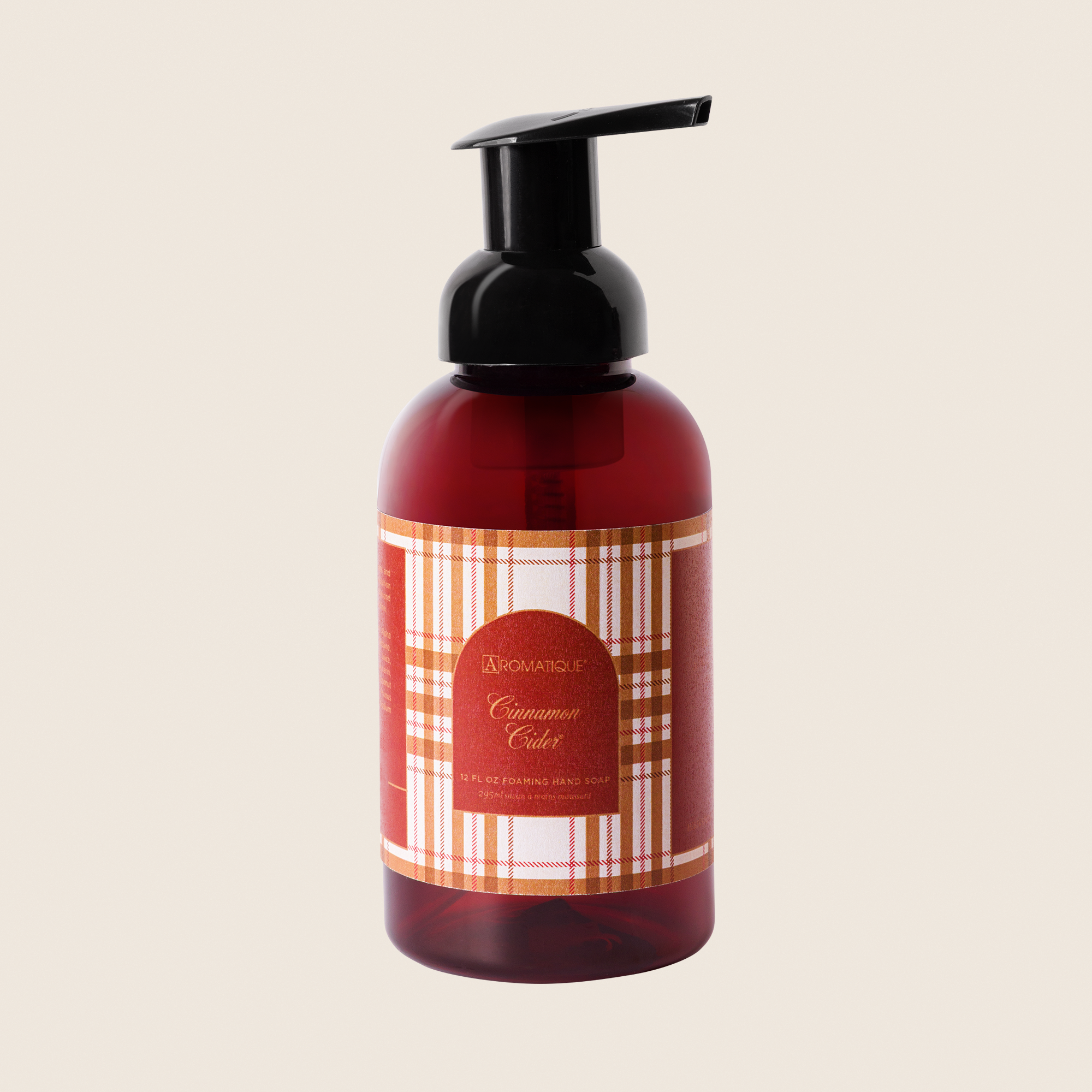 Amber foaming hand soap bottle with black pump wrapped in red plaid paper