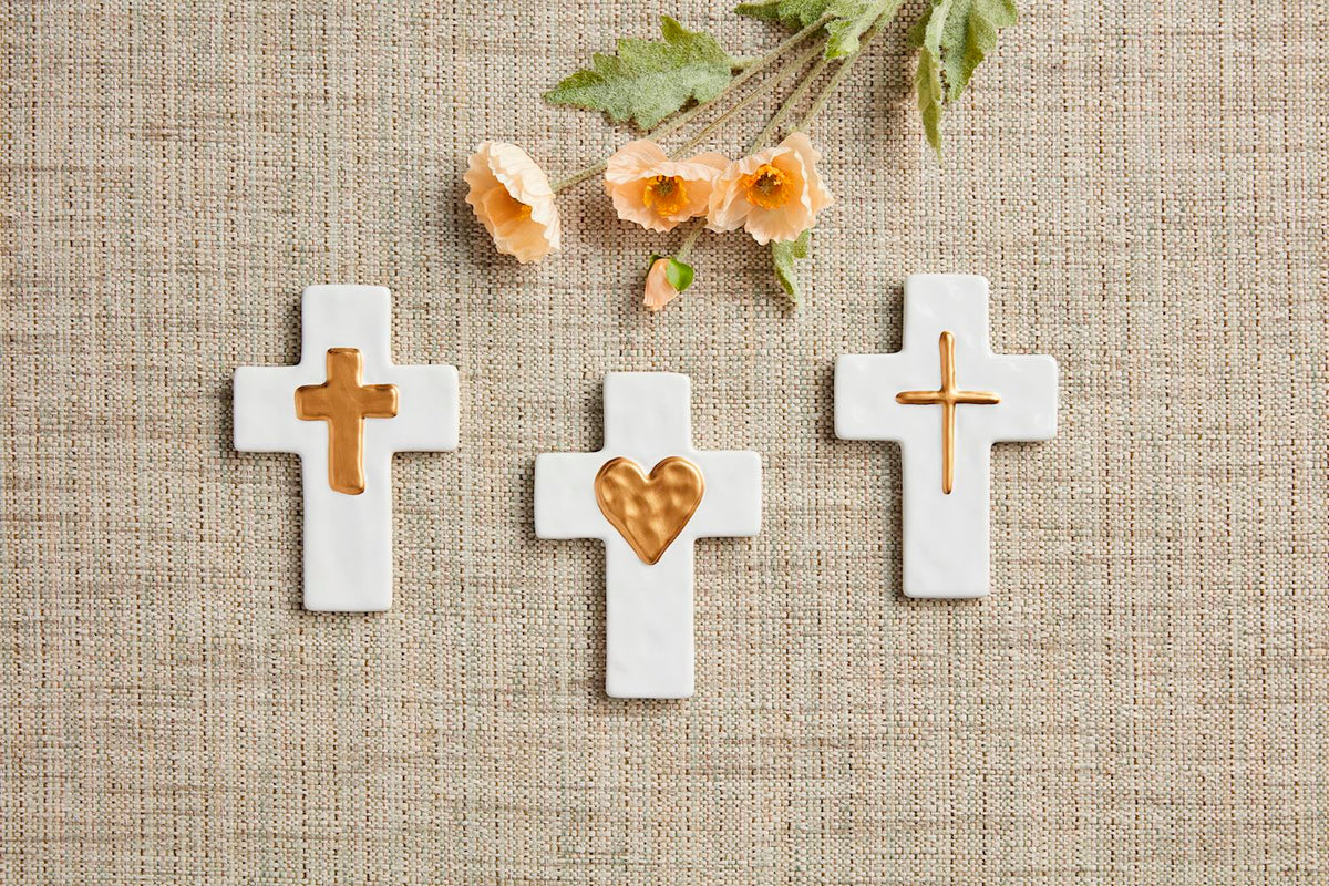 Ceramic wall art with gold accents featuring a minimalist geometric silhouette.